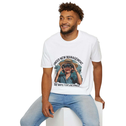 Man wearing funny 'Under new management' T-shirt, humorously referencing 'see wife for details'
