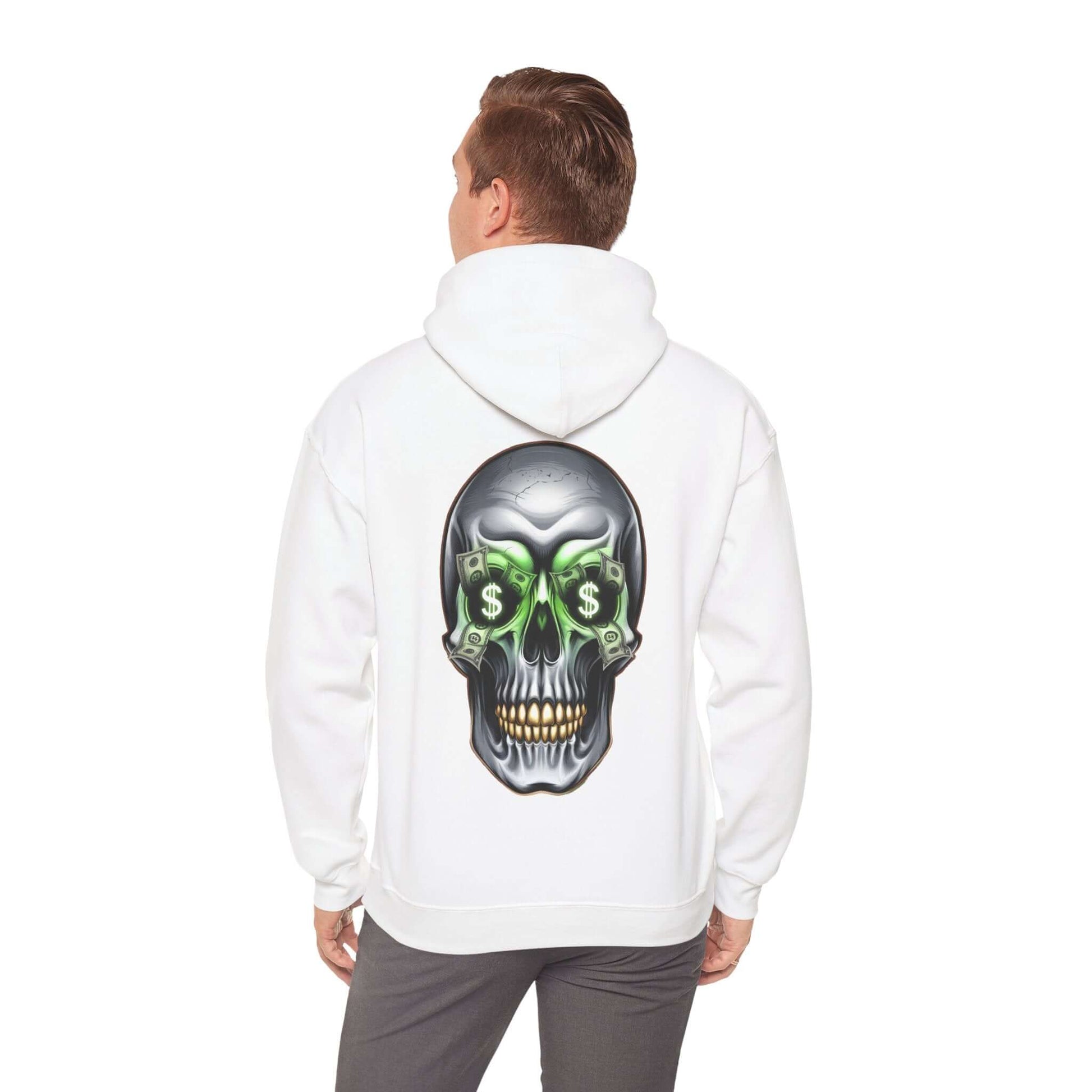 Man wearing a white hoodie featuring a cool skull design with dollar bills in its eye sockets, showcasing an edgy streetwear vibe.