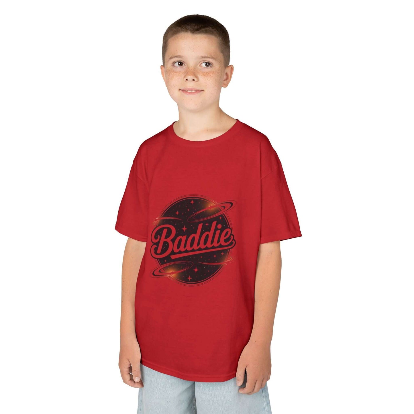 Child wearing a red kids tee with retro 'Baddie' universe design, featuring planets and stylish text.