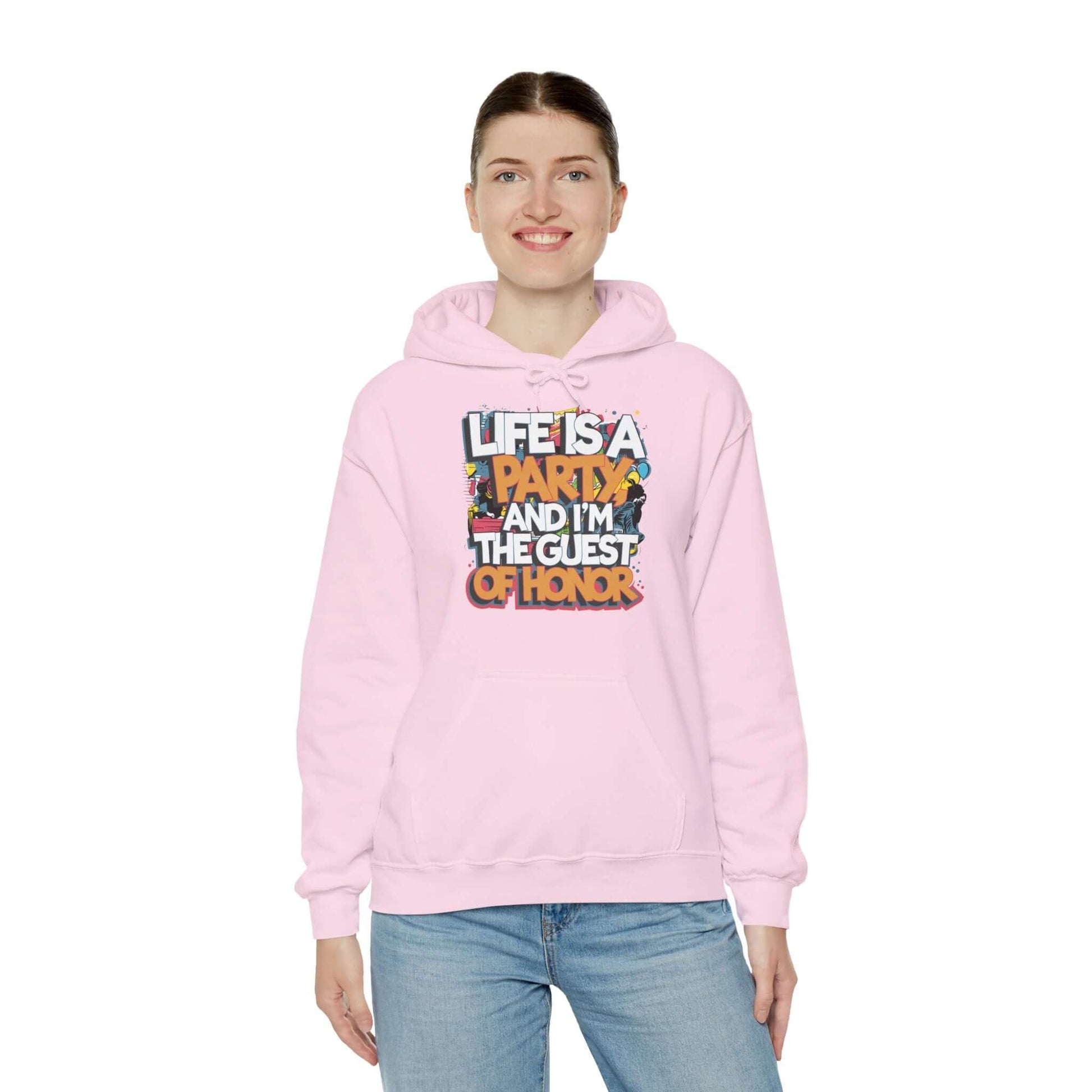 Unisex pink hooded sweatshirt with funny party quote 'Life is a party and I'm the guest of honor'.