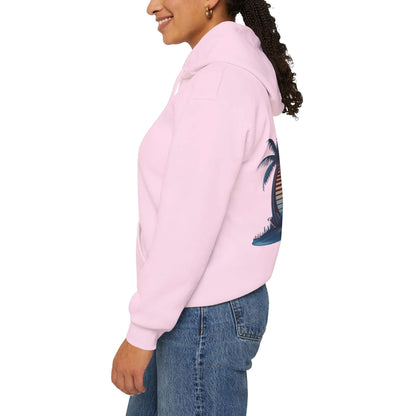 Side view of a pink hooded jumper featuring a sunset surfer and palm trees design, perfect for beach wear.