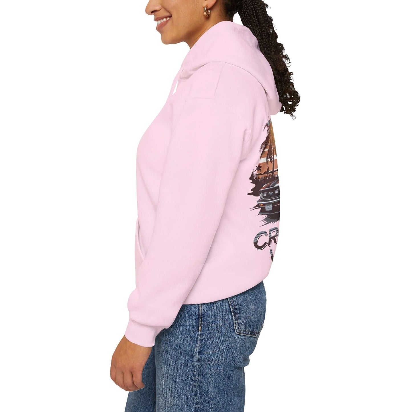 Side view of a pink Cruising Vibes hoodie featuring a retro sunset beach design and American muscle car.