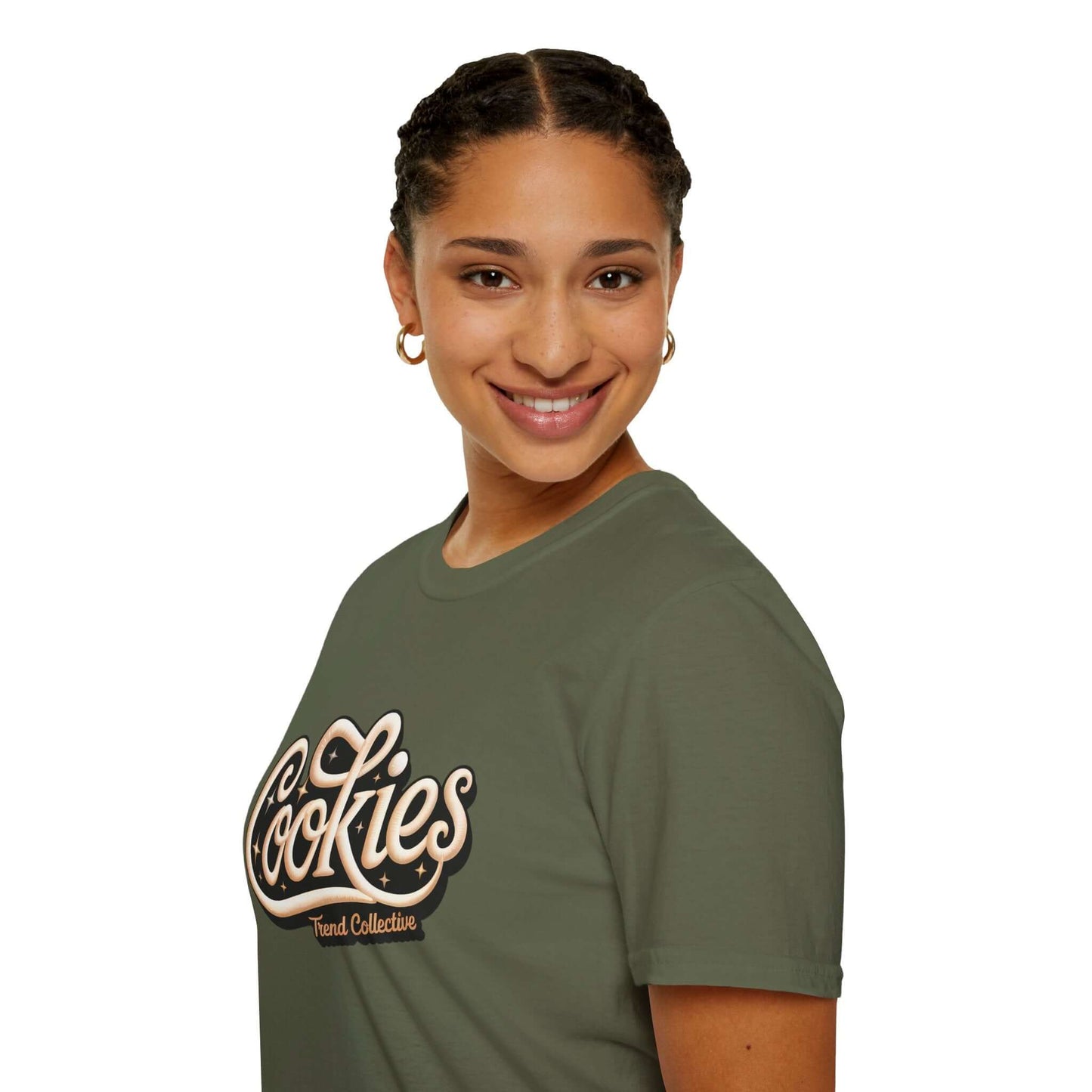 Smiling woman wearing a trendy Cookies Trend Collective T-Shirt in olive green with stylish cursive writing.