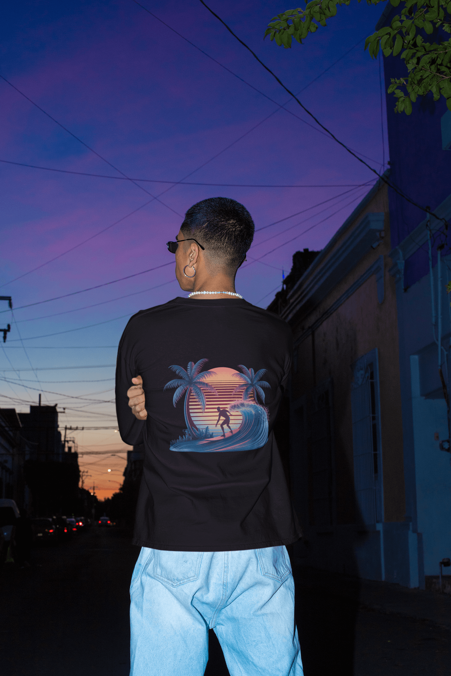 Long sleeve tee featuring sunset surfer illustration with synth-wave effect and palm trees, ideal for surf and beach wear.