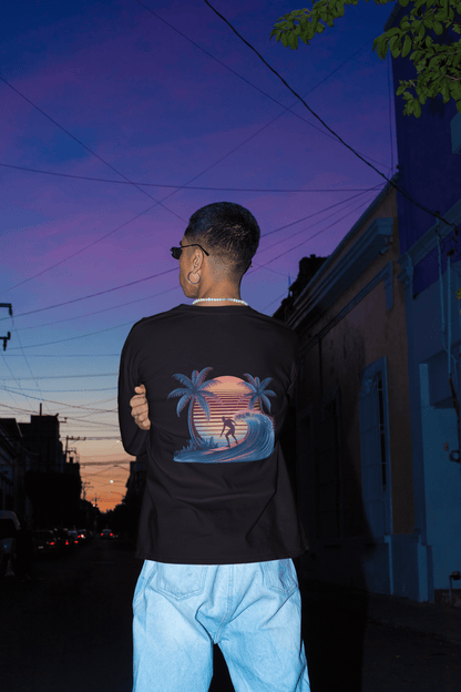 Long sleeve tee featuring sunset surfer illustration with synth-wave effect and palm trees, ideal for surf and beach wear.