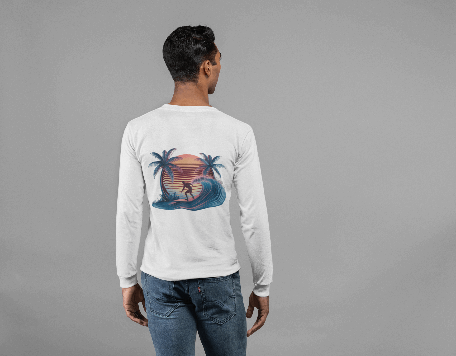 Long sleeve t-shirt featuring sunset surfer riding a wave with palm trees, synth-wave design for beach and surf wear.