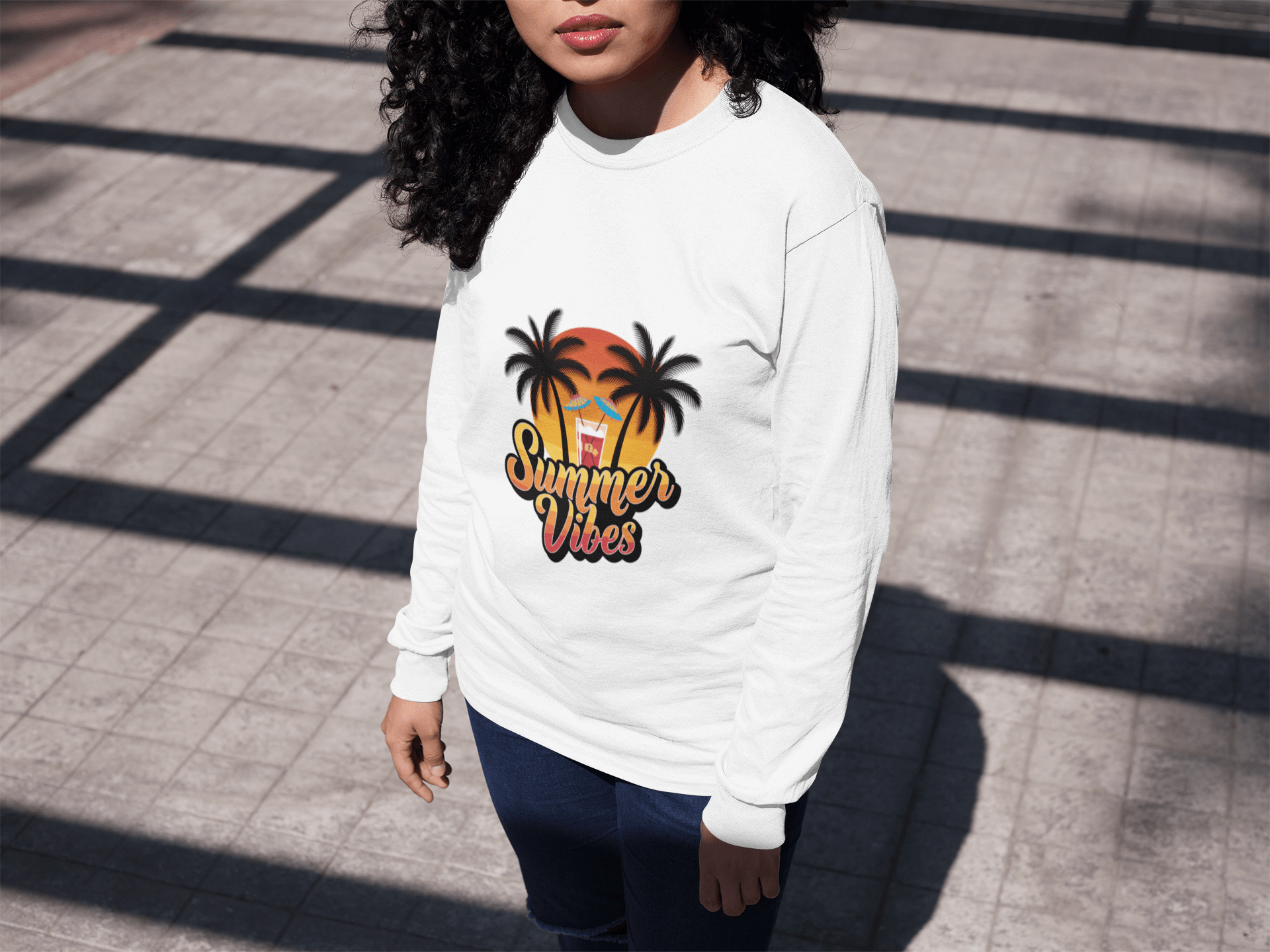 Long sleeve tee featuring sunset, tropical drink, palm trees, and retro summer vibes design, perfect for beach wear.
