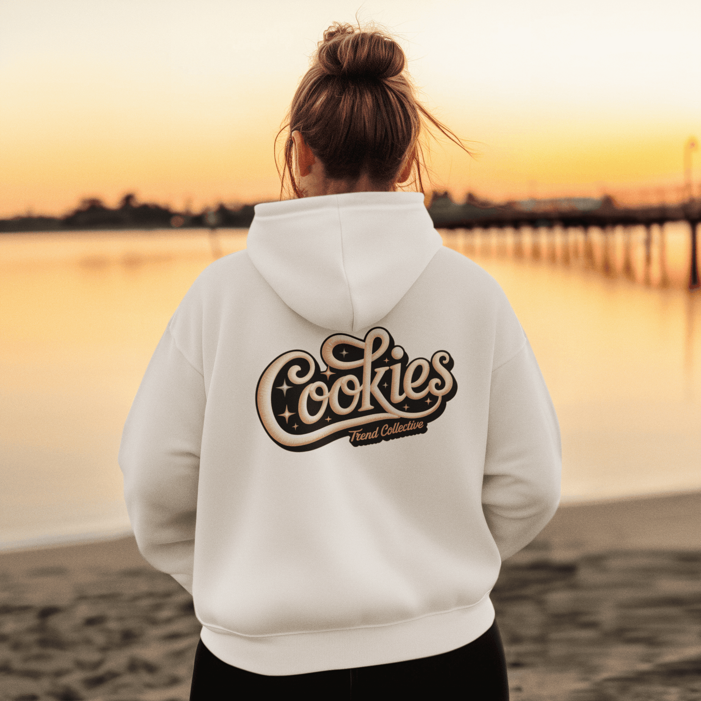 Cozy white hoodie with vintage-inspired 'Cookies Trend Collective' hand-lettered design, perfect for retro vibes.