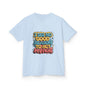 Kids tee in light blue with colorful graffiti style design featuring the quote 'I see no good reason to act my age'.