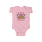 Baby pink bodysuit featuring gingerbread men in Santa hats with 'Baked with Love' text, perfect for the festive season.