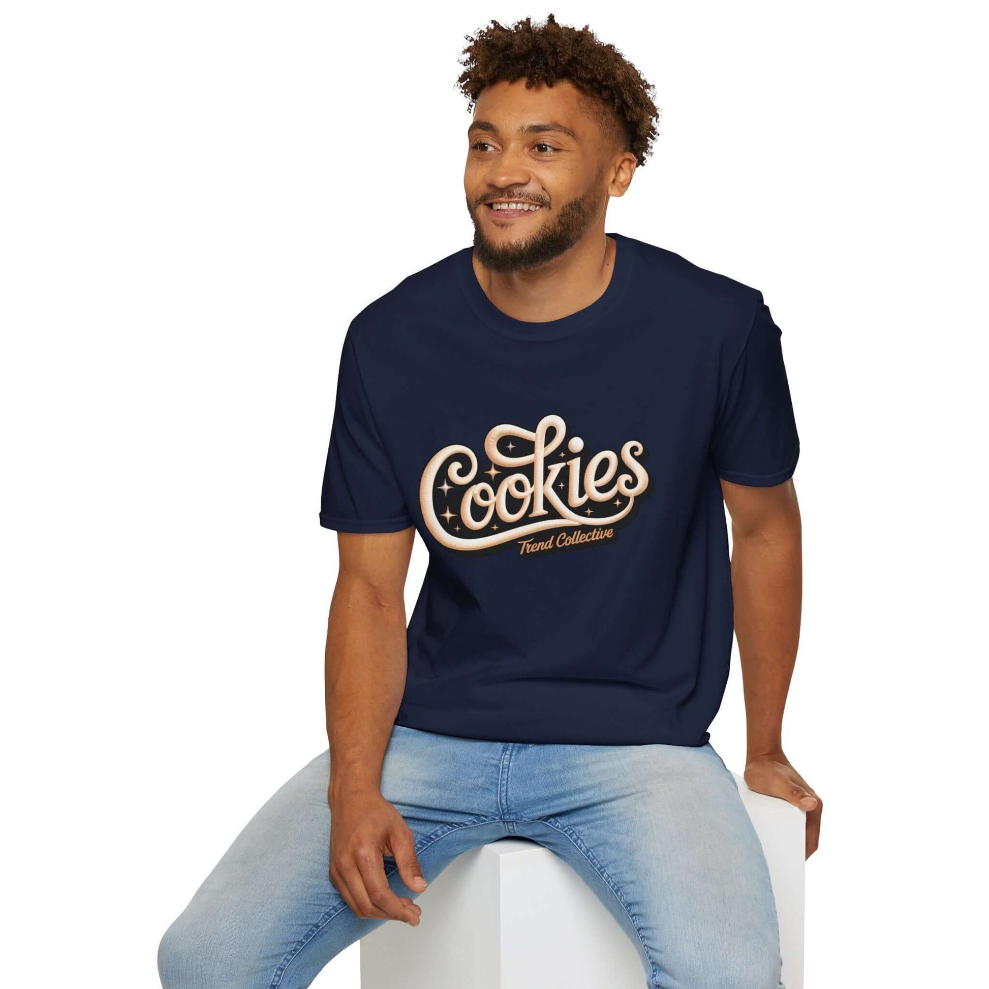 Man wearing a trendy 'Cookies Trend Collective' T-Shirt with cursive writing on a black background.