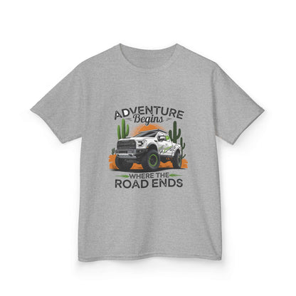 Kids T-shirt featuring off road truck in a desert with text 'Adventure begins where the road ends', perfect for outdoor enthusiasts.