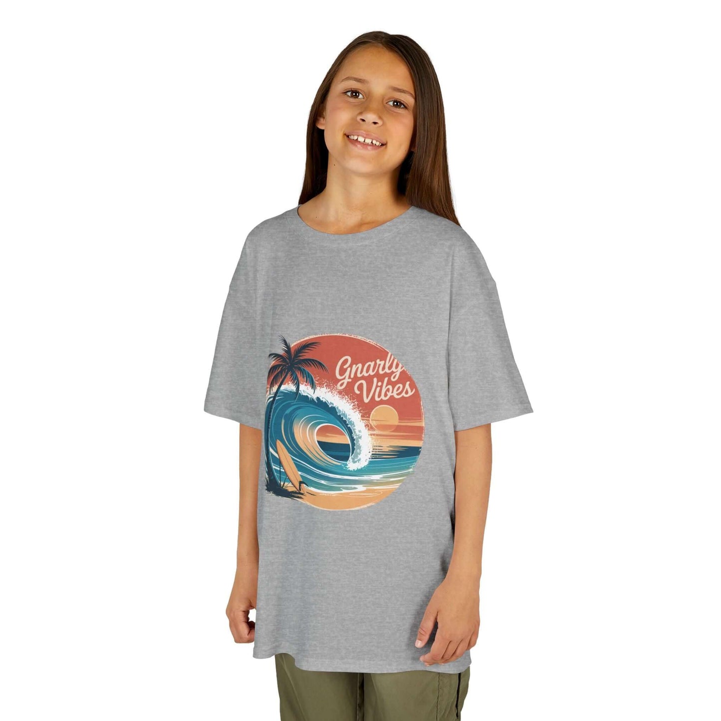 Kids tee with retro big wave surf design and 'Gnarly Vibes' on a sunset beach backdrop.