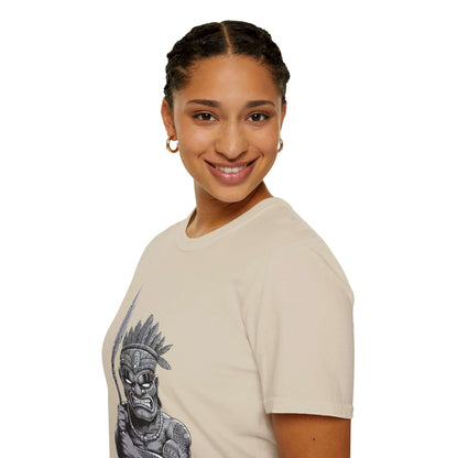 Model wearing a beige Tiki character T-shirt with spear design, showcasing unique and stylish fashion.