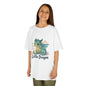Child wearing a white 'Little Dragon' cartoon character Kids Tee, showcasing a playful dragon design.