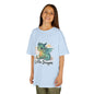 Smiling child wearing a blue kids tee featuring a cute 'Little Dragon' cartoon design.