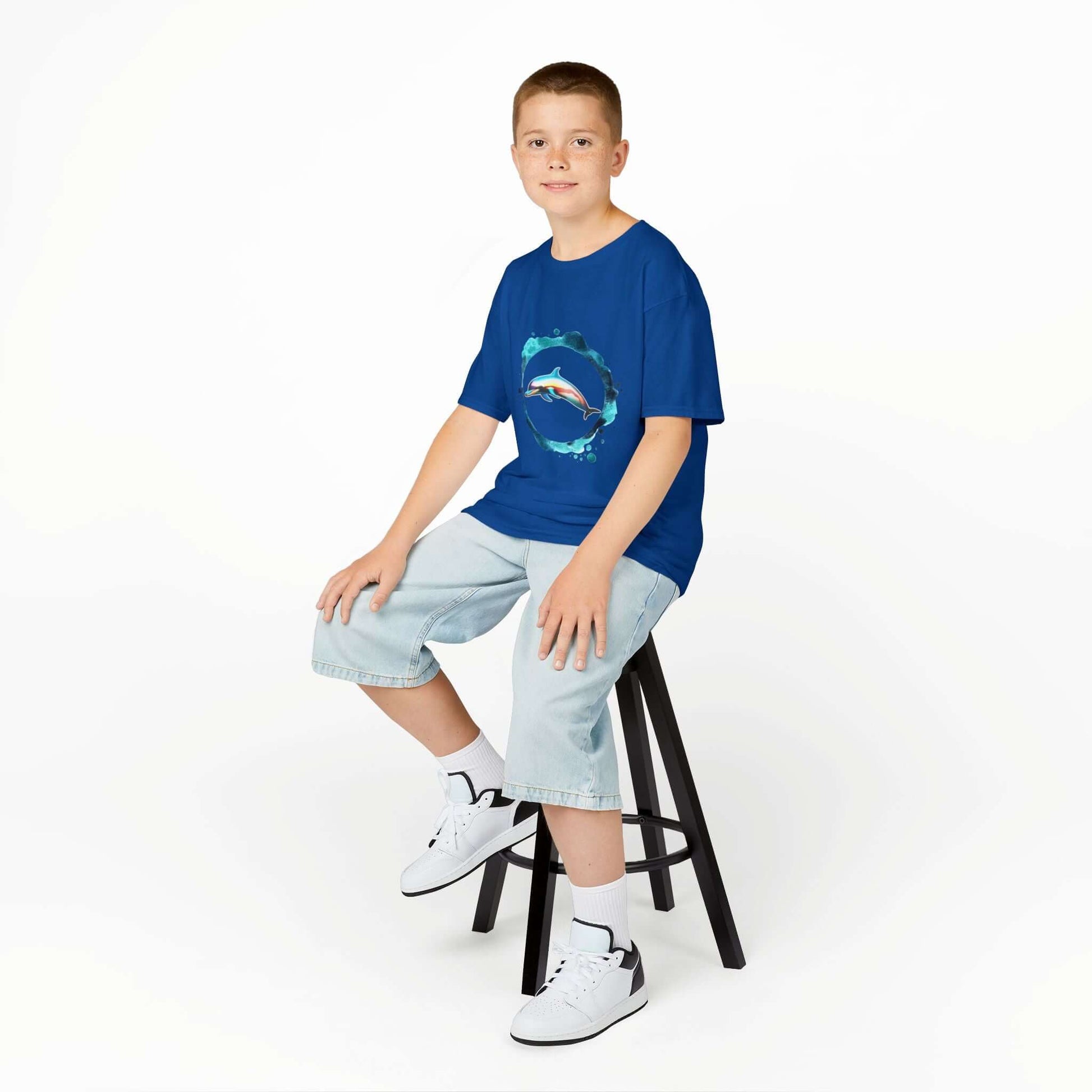 Kid's T-shirt with a colorful dolphin jumping through a ring of water, perfect for animal lovers.