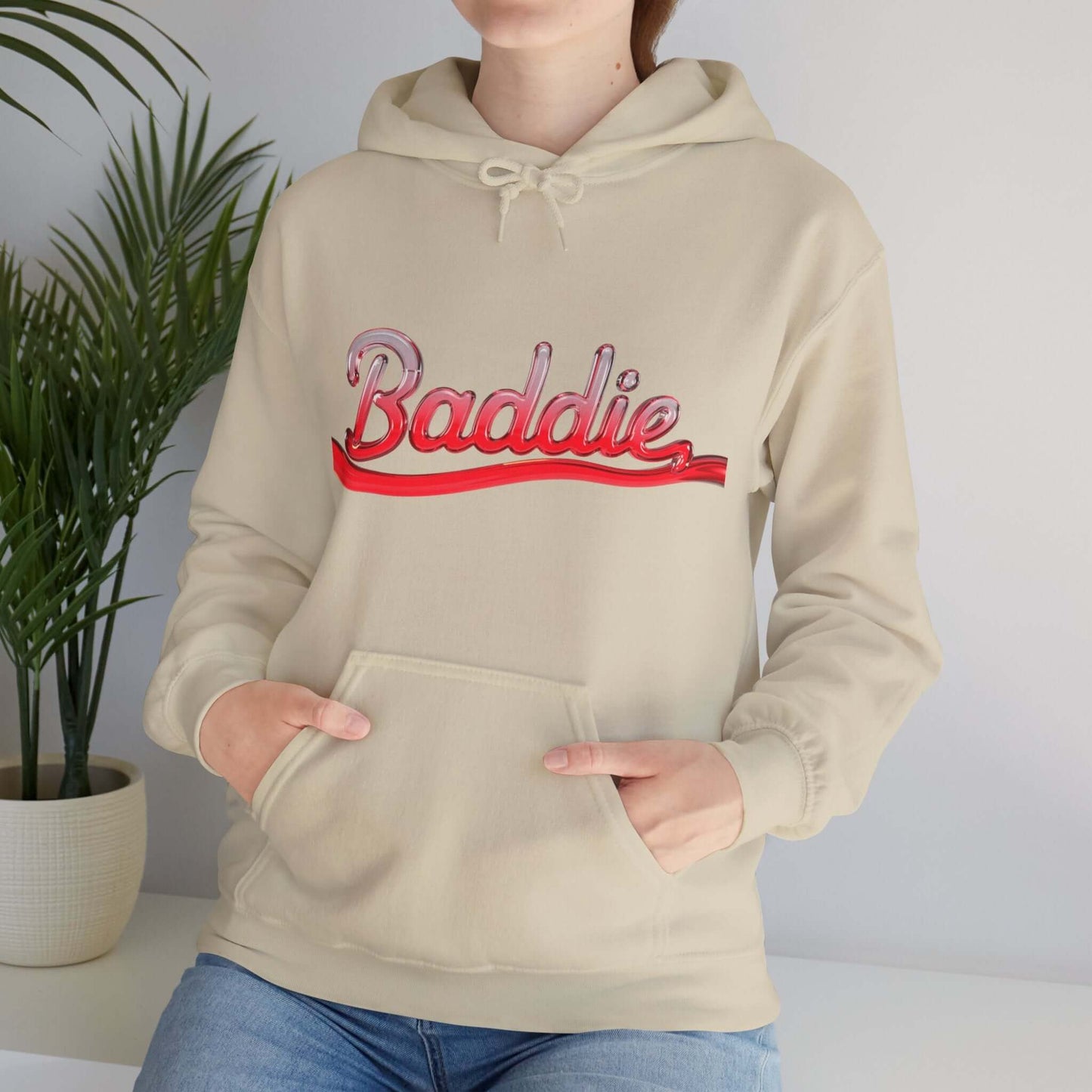 Hooded sweatshirt with 'Baddie' typography design in red liquid text, perfect for trendy streetwear.