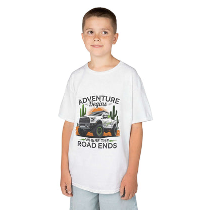 Kids T-shirt featuring off road truck in a sunset desert with text 'Adventure begins where the road ends'.